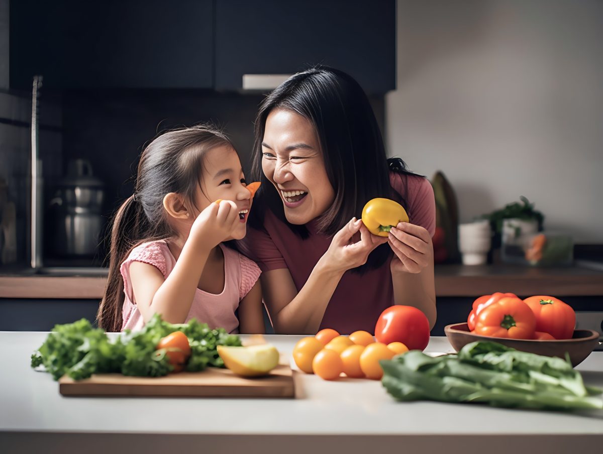 Mother having fun with her daughter in the kitchen
