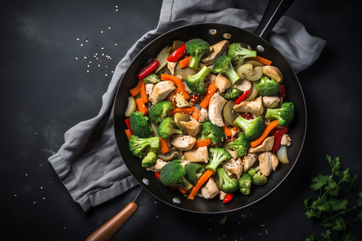 Stir fry chicken and vegetables in skillet